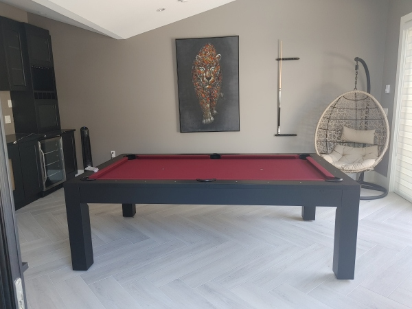 A furnished room featuring a pool table, chair, and deep-seated chair.
