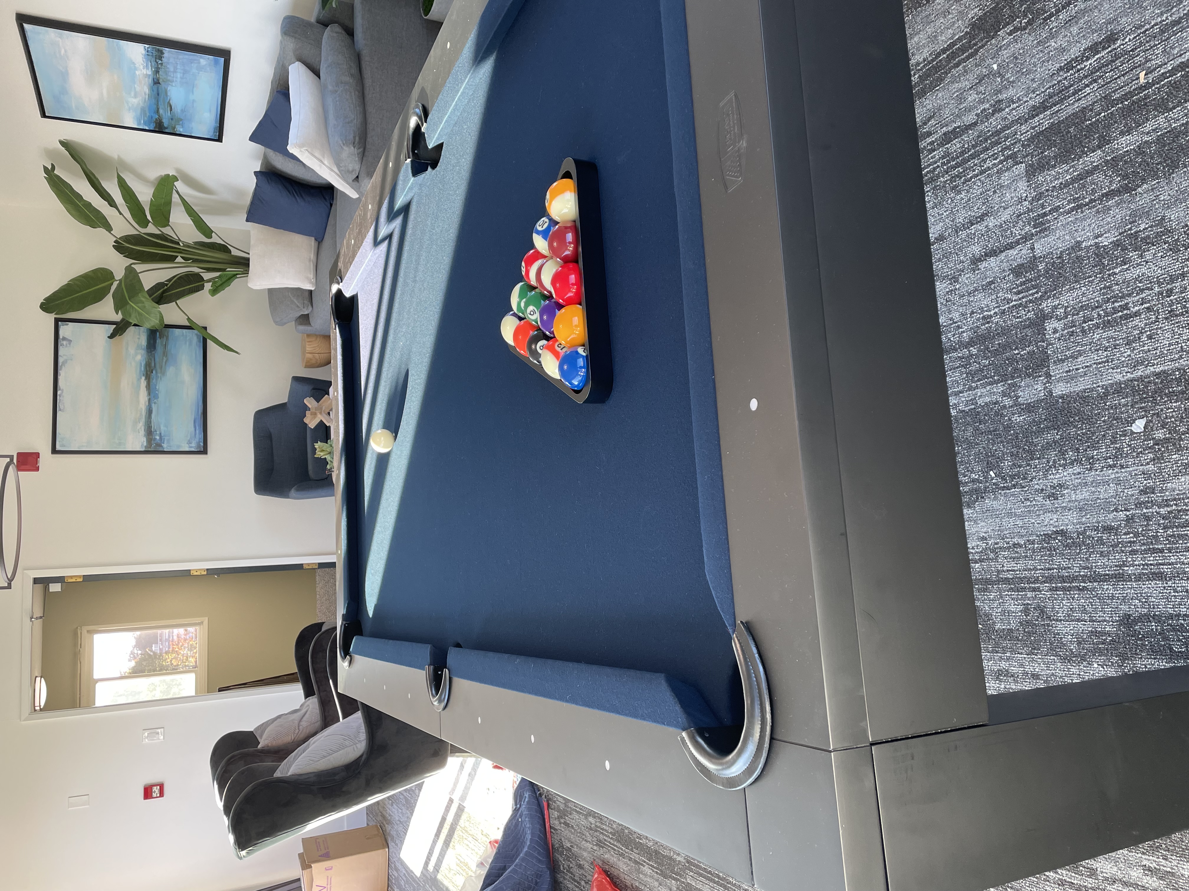 A blue pool table with balls in play.