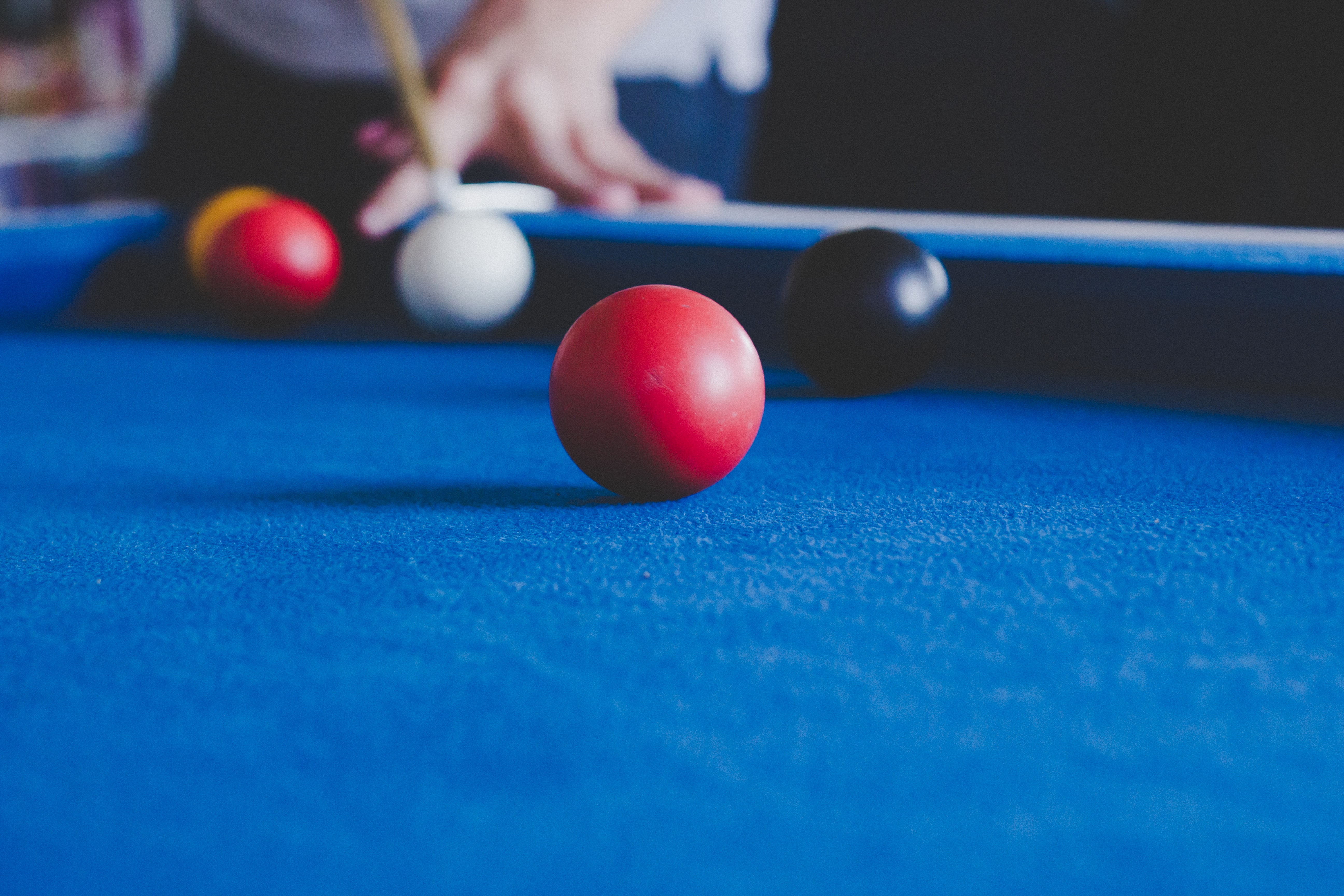 Playing snooker on a blue felt pool table