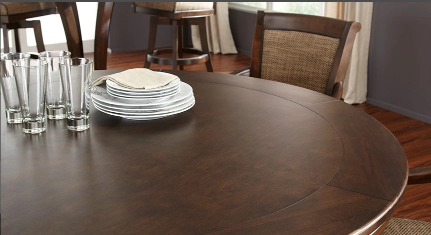 Round wood convertible poker dining table set with plates and drinking glasses.
