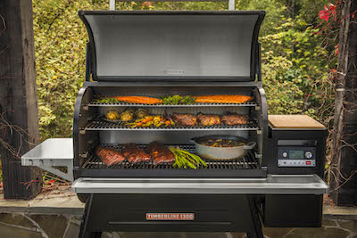 Traeger Timberline 1300 with lid open and food on the grill.